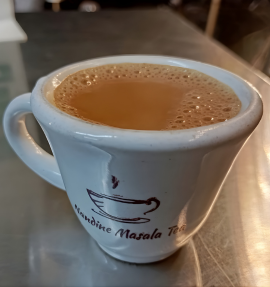 Nandini Masala Chai pack with warm spices around the cup